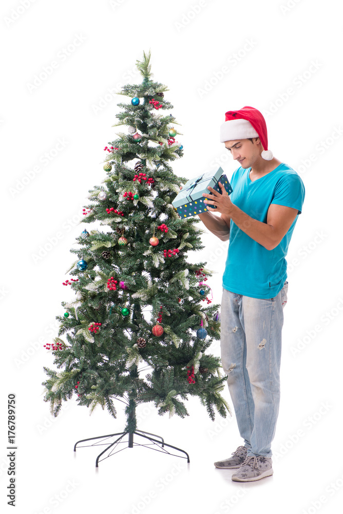 Young man decorating christmas tree isolated on white Young man decorating christmas tree isolated on white