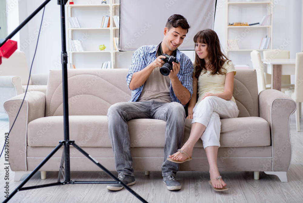 Fototapeta premium Young photographer working in photo studio
