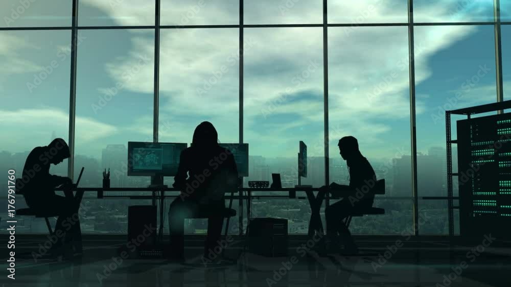 Silhouettes of hackers at work Silhouettes of hackers at work