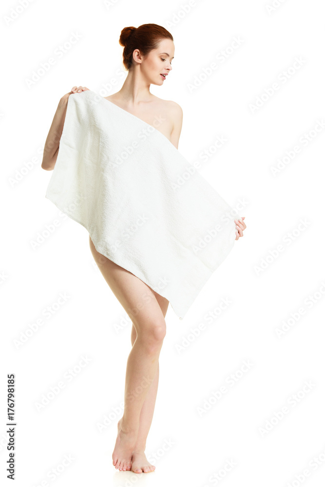 Naked woman hiding behind towel after bath Naked woman hiding behind towel after bath