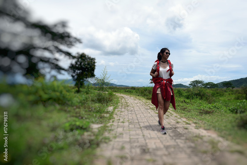 Asian woman backpacking, in forest . Background for Travel , holiday and vacation concept .