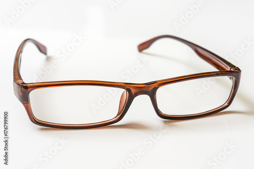 Modern brown eyeglasses isolated on white