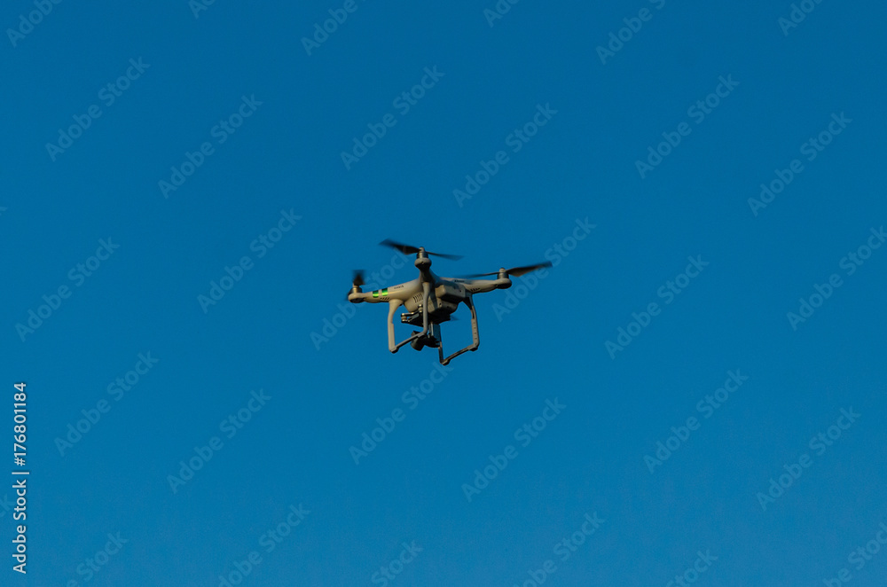 White drone in blue sky White drone in blue sky