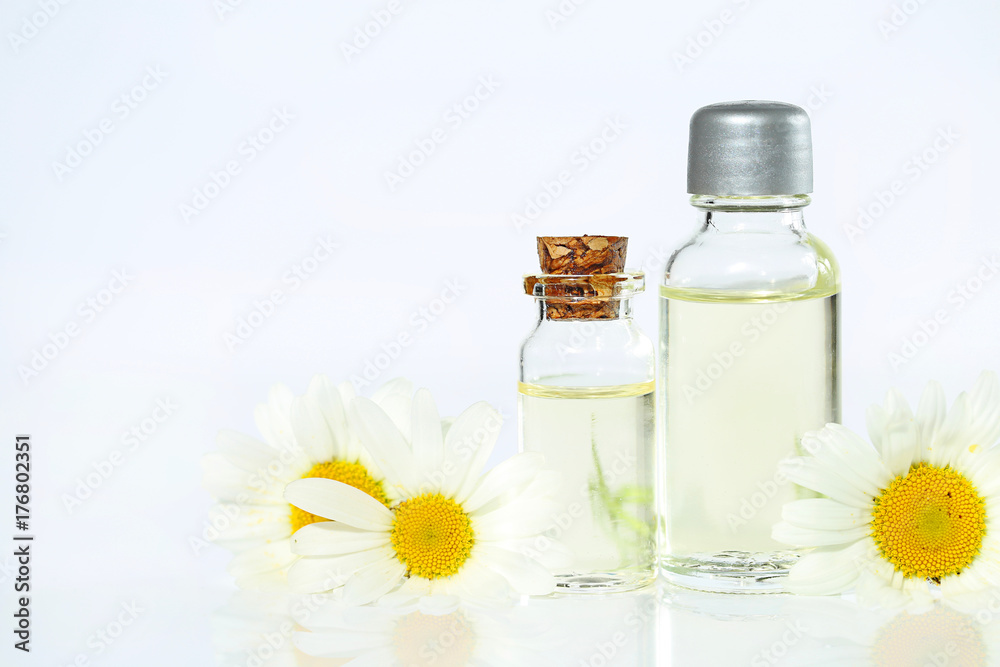 chamomile essential oil. chamomile oil in a transparent bottle and daisy flowers on a light background. Natural essential oils chamomile essential oil. chamomile oil in a transparent bottle and daisy flowers on a light background. Natural essential oils