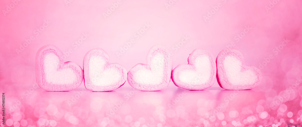 the marshmallow heart shape in cup on pink background with love concept