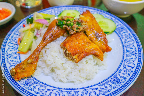 Grilled chicken on top with rice in Combodia style, selective focus photo