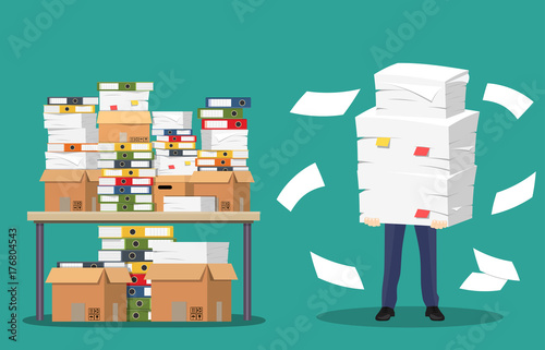 Businessman holds pile of office papers and documents.