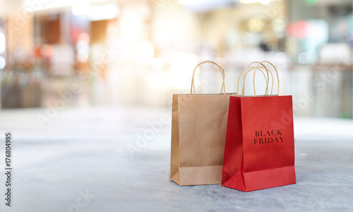 Black Friday shopping bags on the floor outdoors with the mall background