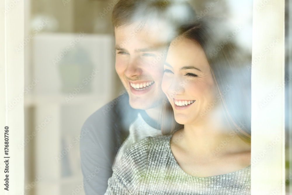 Fototapeta premium Couple in love looking through a window
