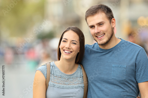 Front view of a couple walking on the street