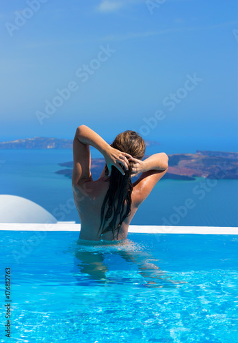 Woman relaxing in infinity swimming pool