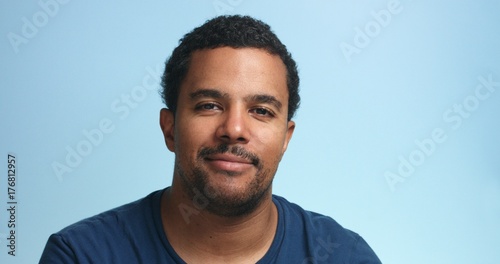 sleepy mixed race man portrait on a deep blue background