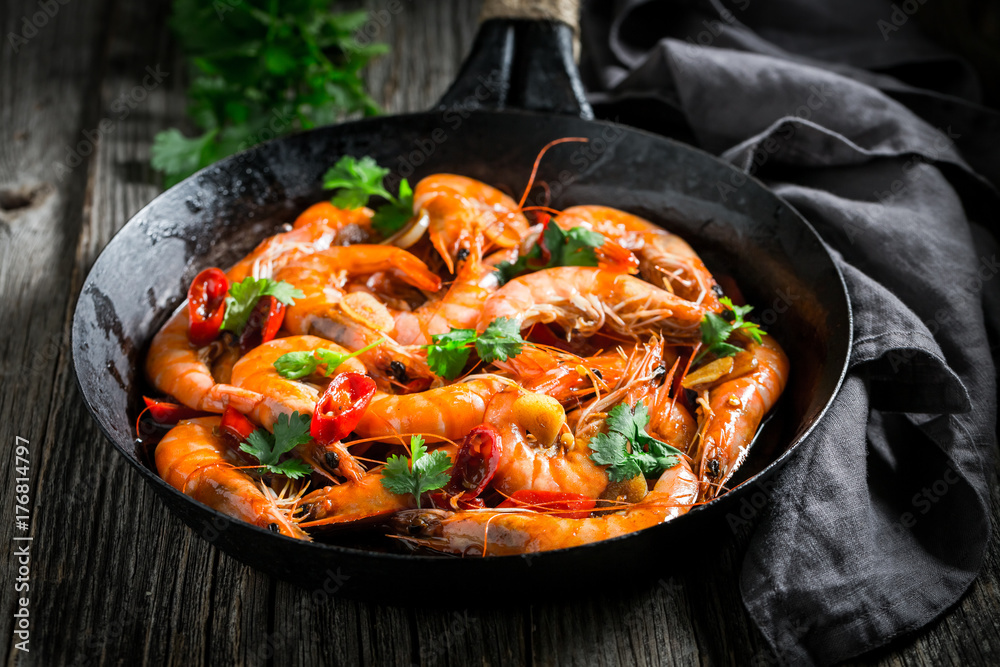 Spicy shrimps on pan with garlic, coriander and peppers Spicy shrimps on pan with garlic, coriander and peppers