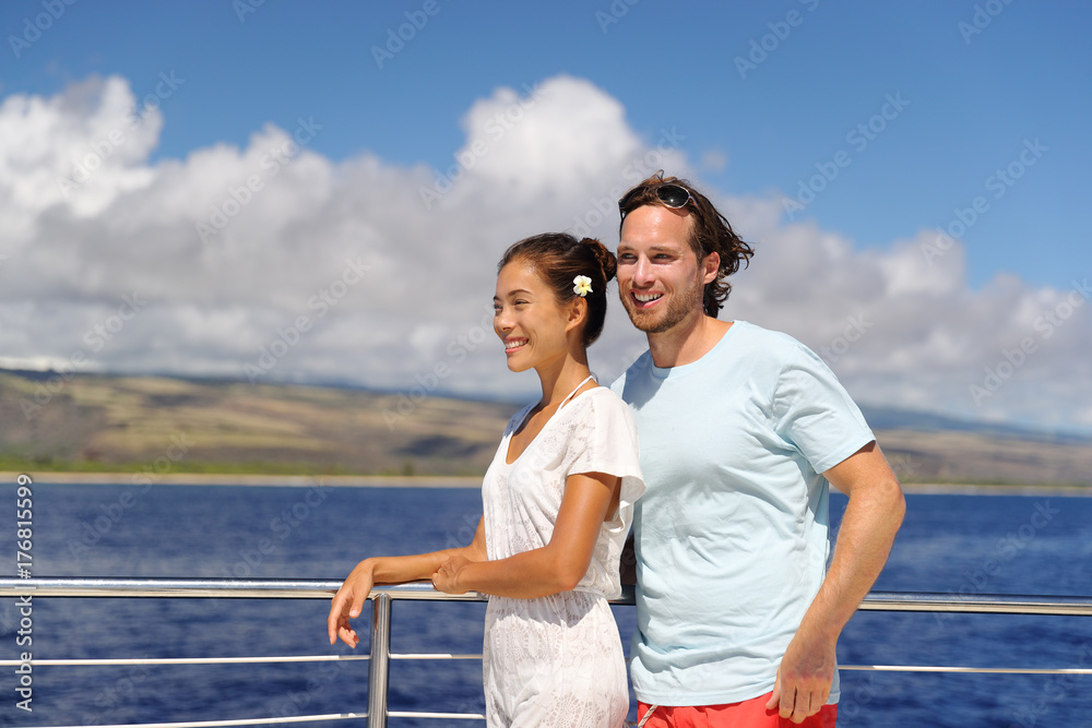 Cruise vacation happy couple relaxing on yacht in Hawaii. Young people having fun on scenic boat tour in Kauai, ocean tourism activity. Asian woman, Caucasian man. Cruise vacation happy couple relaxing on yacht in Hawaii. Young people having fun on scenic boat tour in Kauai, ocean tourism activity. Asian woman, Caucasian man.