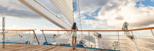 Luxury cruise ship vacation woman on deck banner panorama. Travel in Tahiti on sail boat, exotic destination. Tourism in oceania. Boat sailing away on tropical getaway