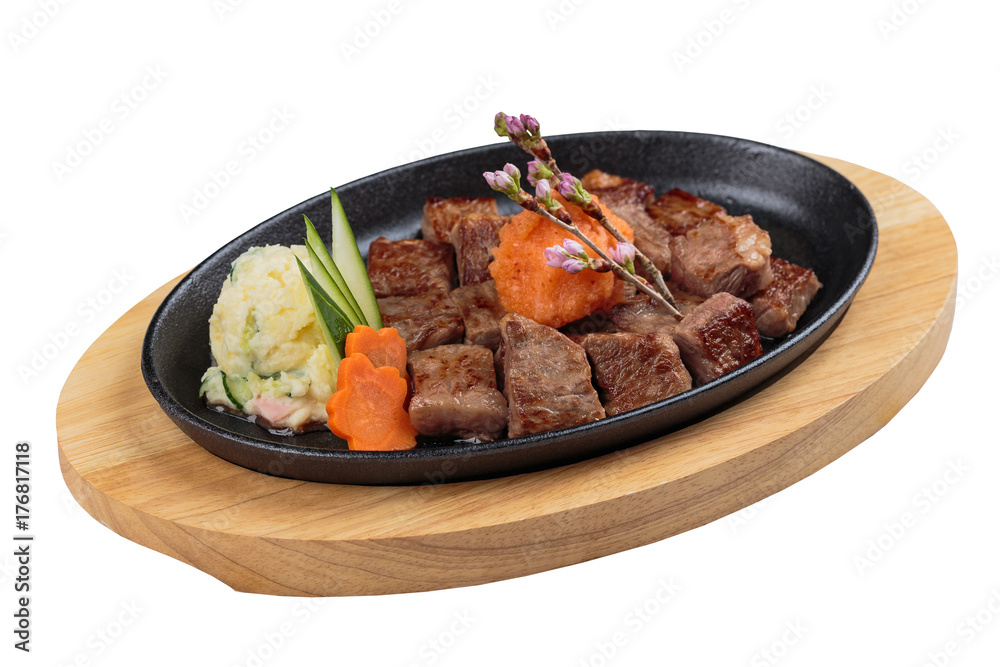 Isolated medium rare wagyu steak topping with mince carrot on hot plate and wooden plate served with potato salad. Isolated medium rare wagyu steak topping with mince carrot on hot plate and wooden plate served with potato salad.