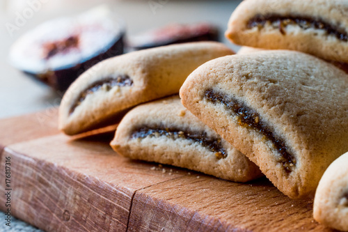 Fig Cookies with fruits on wooden surface.
