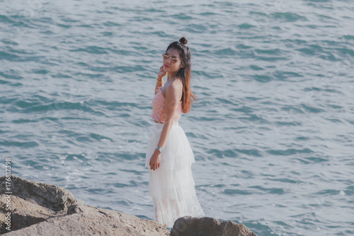 Girl women Asian hipster wearing a white skirt by the sea