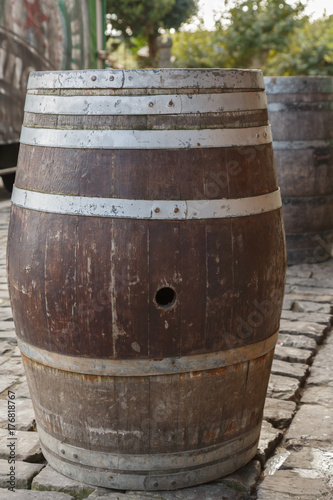 An old wine barrel which is used as a bar table in the daytime on the street