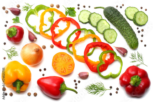 mix of sliced cucumber, garlic, sweet bell pepper and parsley isolated on white background. top view