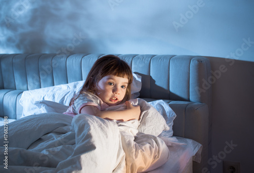 The girl feels the fear while lying in bed