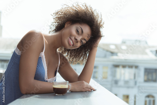 Outgoing young girl tasting beverage in morning © Yakobchuk Olena