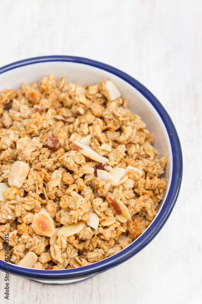 granola with nuts in the bowl on wooden background granola with nuts in the bowl on wooden background