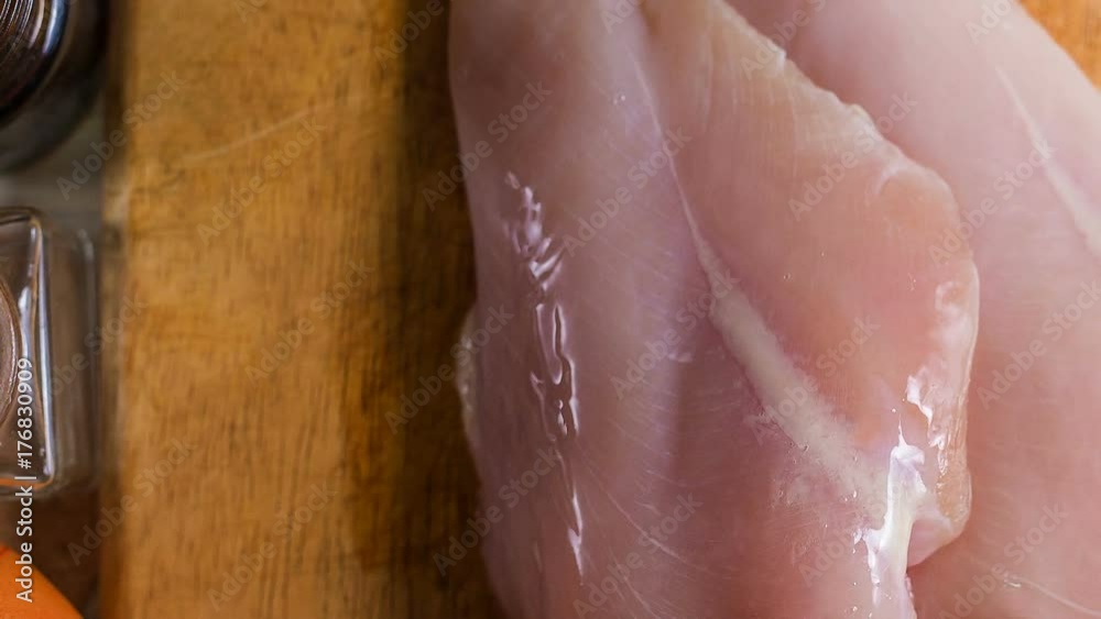 The Raw chicken breast with dill ready for cooking The Raw chicken breast with dill ready for cooking