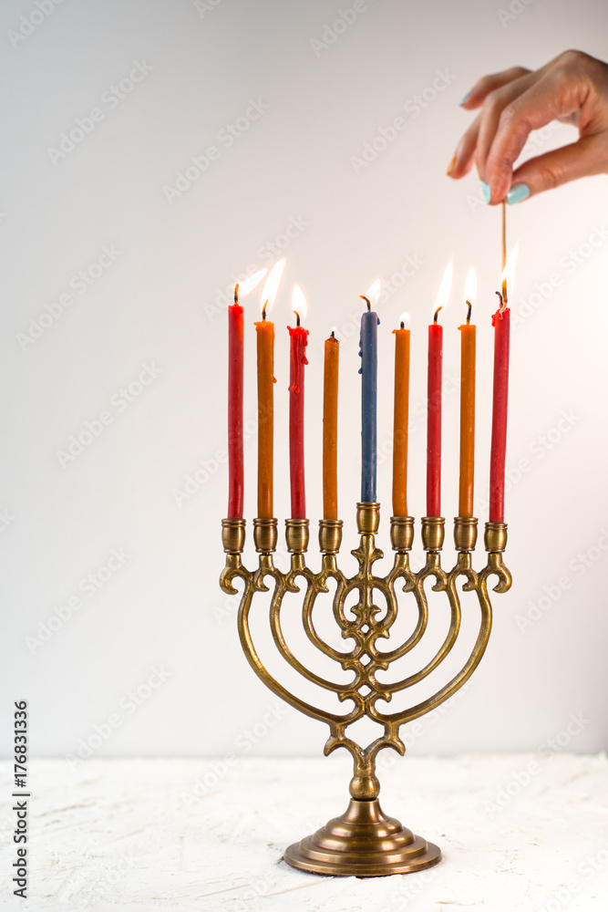 Light candles on chanukiah for the holiday side view Light candles on chanukiah for the holiday side view