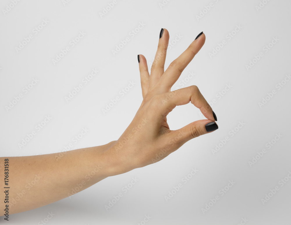 Female hand with black nails, gesturing ok. Isolated on white background. Shallow depth photography. Stock Photo | Adobe Stock Female hand with black nails, gesturing ok. Isolated on white background. Shallow depth photography. Stock Photo | Adobe Stock