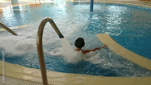 femme dans une piscine sous jet d'eau photo