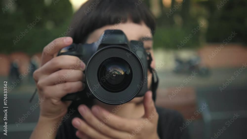 Young female tourist or urban nomad explorer or adventurer clicks shutter on professional photo camera, creates photographs for social media as freelancer or content creator Young female tourist or urban nomad explorer or adventurer clicks shutter on professional photo camera, creates photographs for social media as freelancer or content creator