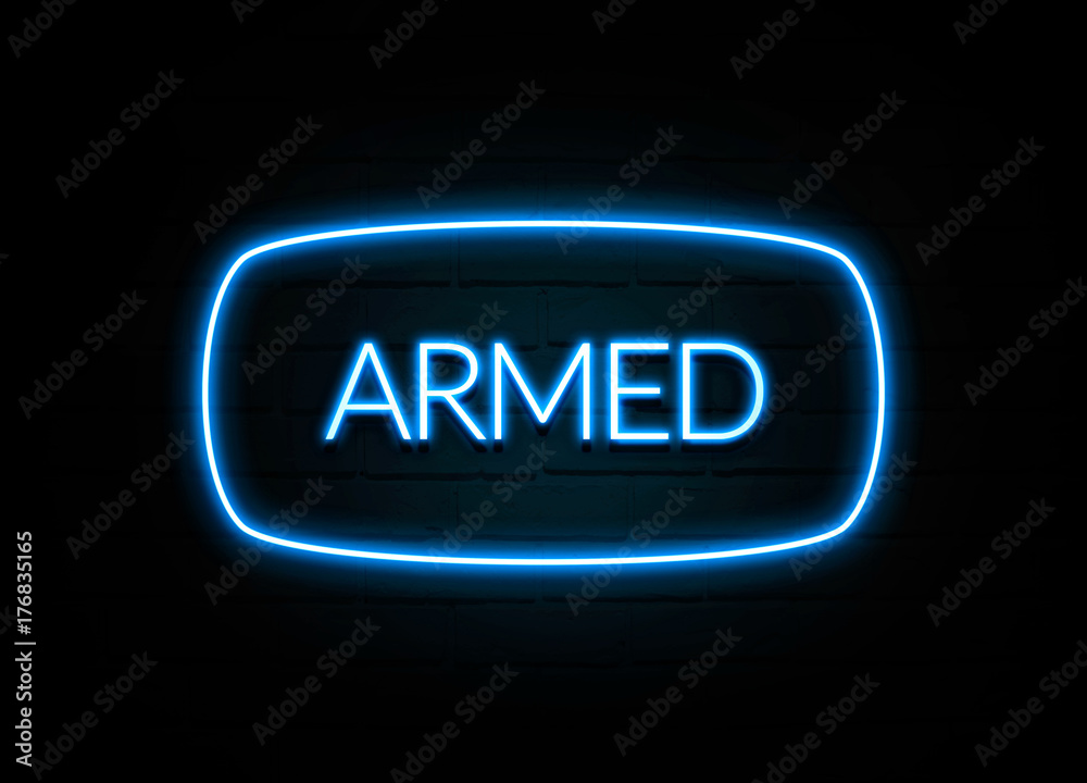 Armed - colorful Neon Sign on brickwall Armed - colorful Neon Sign on brickwall