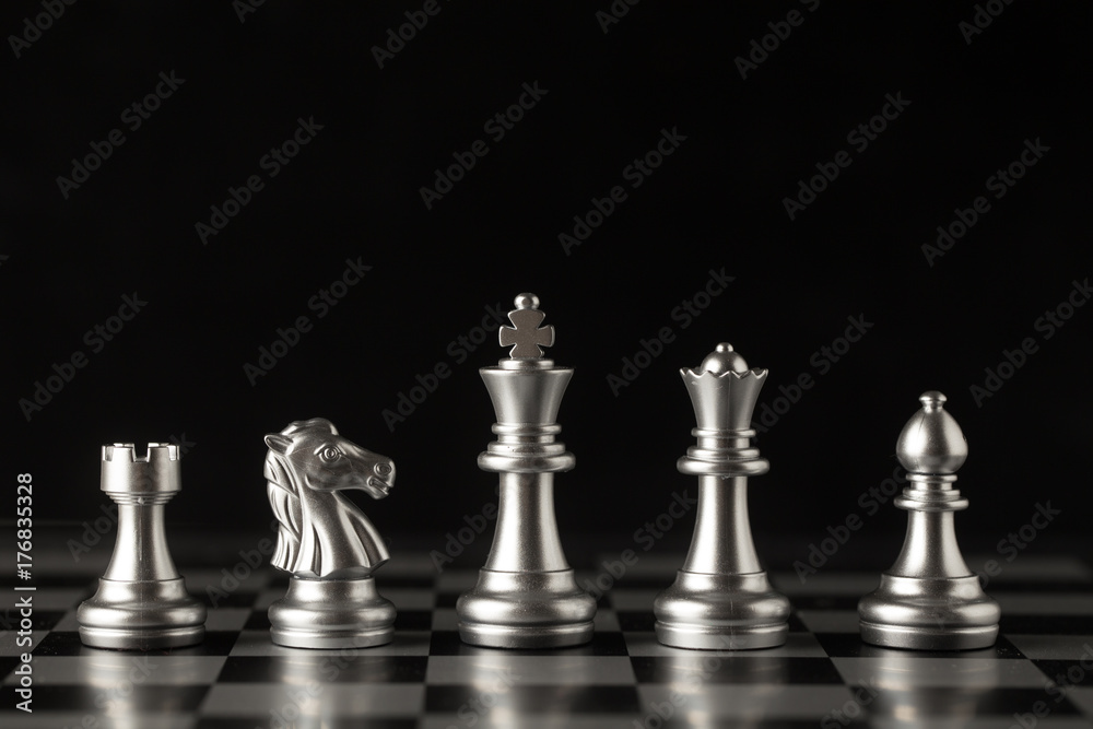 Chess on a chessboard at black background, Business leader concept. Chess on a chessboard at black background, Business leader concept.