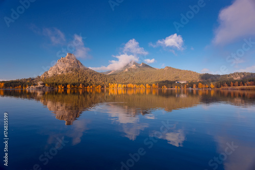Beautiful morning panorama of autumnal landscape with mountain lake.
