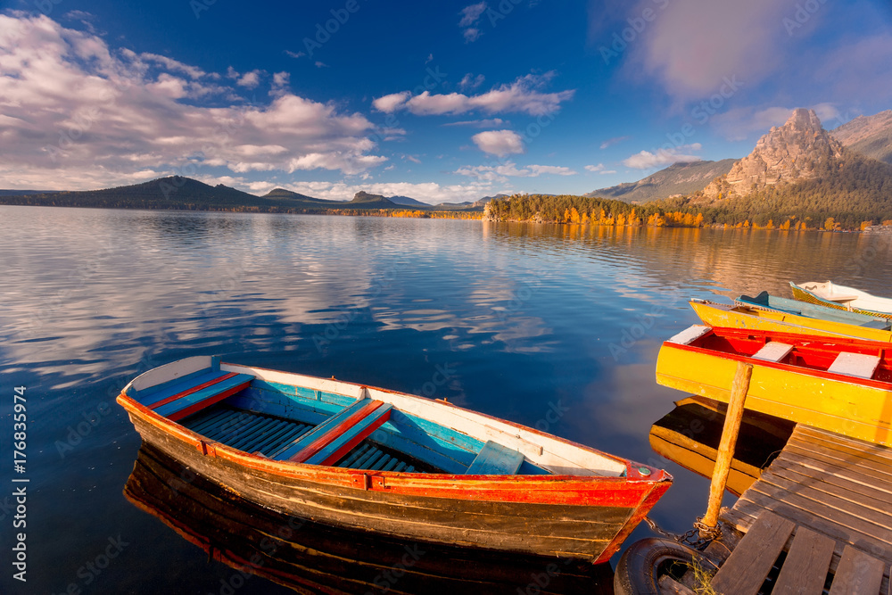 Beautiful morning landscape. Colorful vintage boats on Borovoe lake at Burabay National park in Northern Kazakhstan.