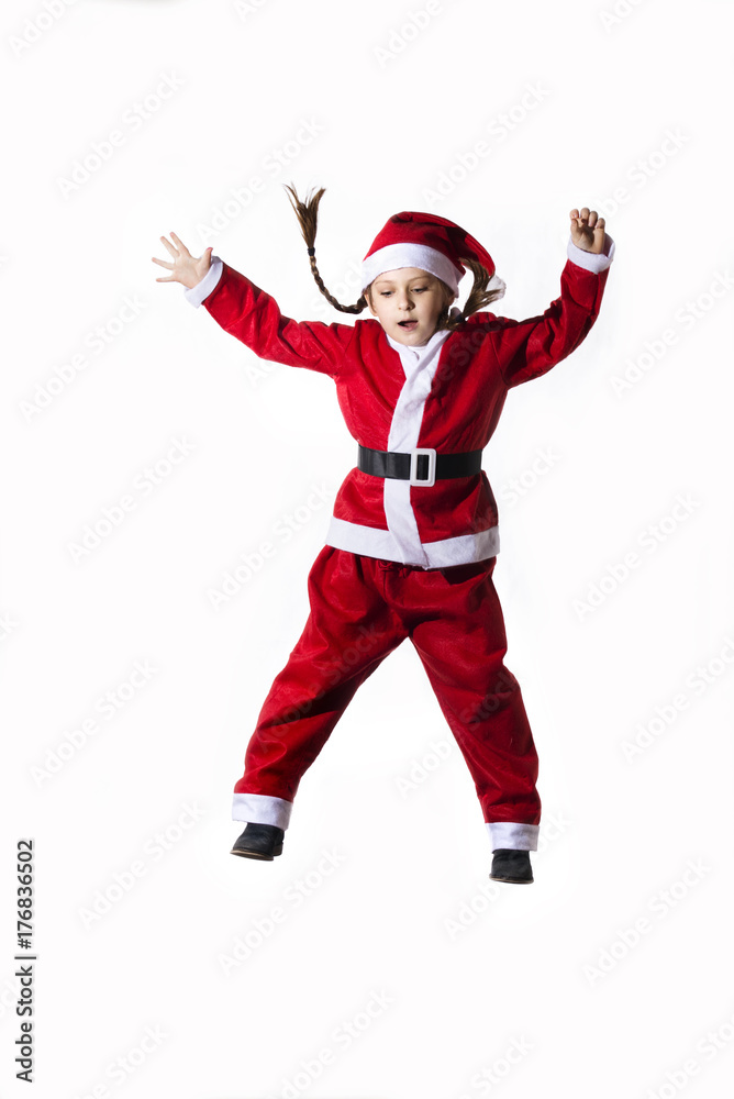 Little caucasian girl dressed as Santa Claus jumping on white background. Little caucasian girl dressed as Santa Claus jumping on white background.