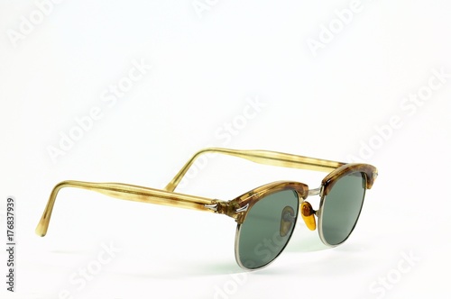 Vintage bakelite sunglasses similar to turtle carapace on white background. Years '50.