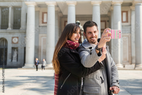 couple taking pictures at prado museum madrid