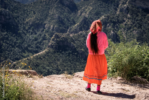 Tarahumara woman wearing bright traditional outfit is seen in Copper Canyons, Chihuahua, Mexico photo