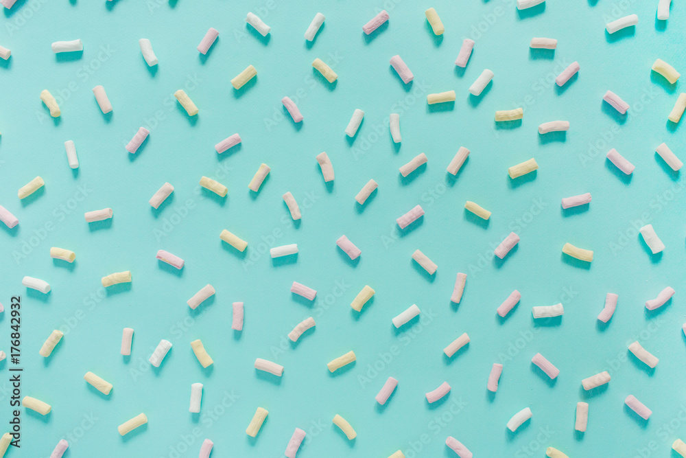 Colorful marshmallow pattern on pastel blue background. Flat lay, top view. Colorful marshmallow pattern on pastel blue background. Flat lay, top view.