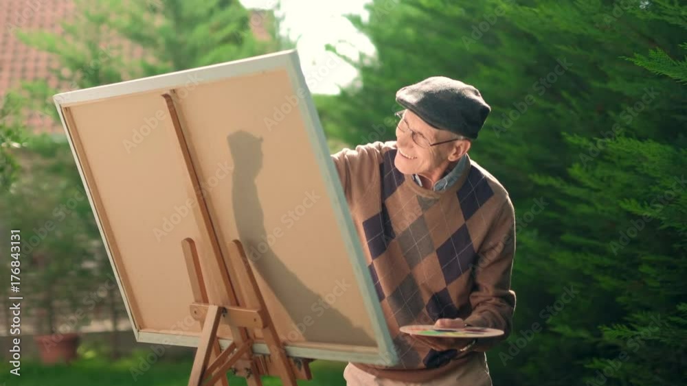 Senior painting on a canvas with a paintbrush Senior painting on a canvas with a paintbrush