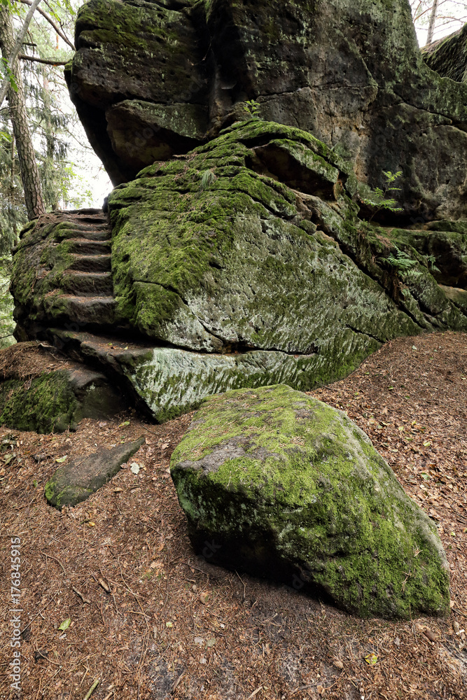 Big stone covered by moss by the stony stairs Big stone covered by moss by the stony stairs