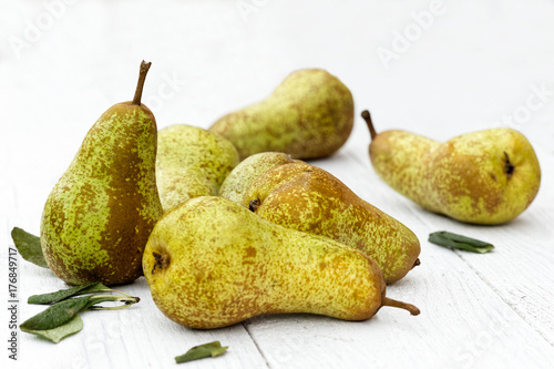 Abate fetel pears with leaves on white painted wood.