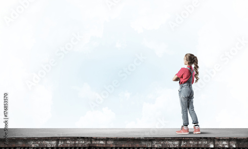Concept of careless happy childhood with girl looking far away © adam121