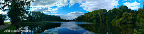 Autumn blue lake with green trees.