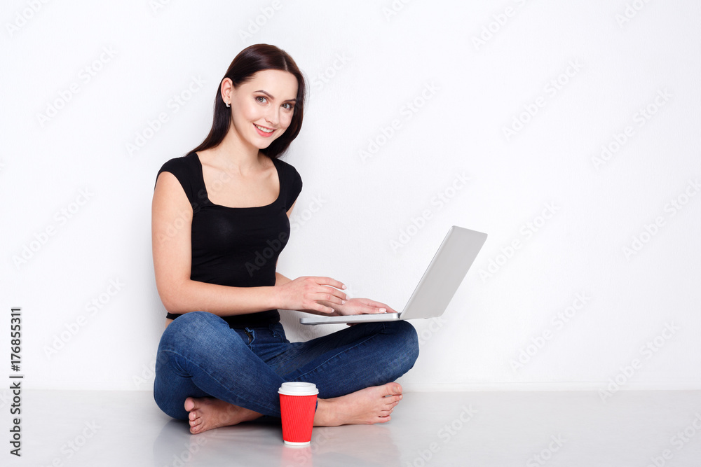 Fototapeta premium Freelancer woman with laptop and coffee at home