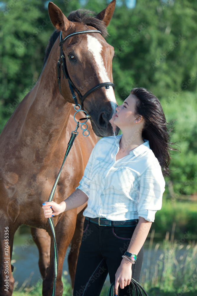 Obraz premium young girl with her horse posing together