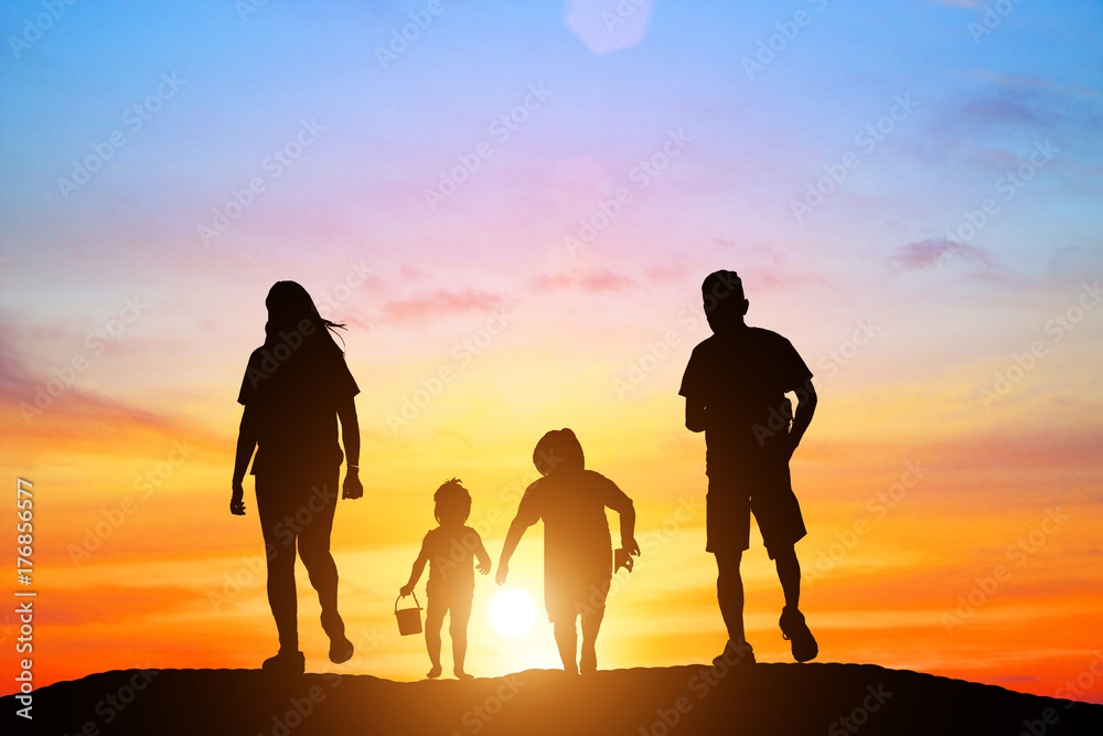 silhouette family  walking on blurry colorful sky at sunset time 