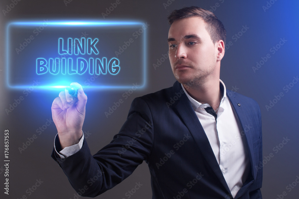 The concept of business, technology, the Internet and the network. Young businessman showing inscription: Link building The concept of business, technology, the Internet and the network. Young businessman showing inscription: Link building